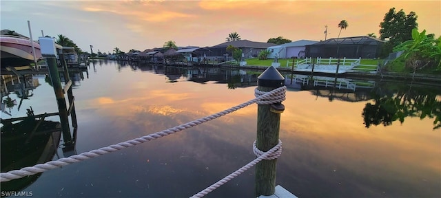 dock area featuring glass enclosure and a water view