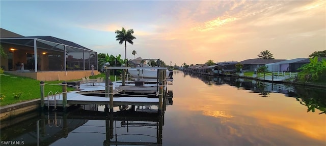 dock area featuring a water view and glass enclosure