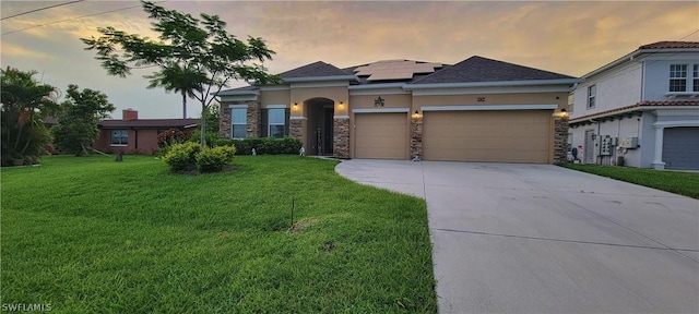 view of front of home featuring a yard and solar panels