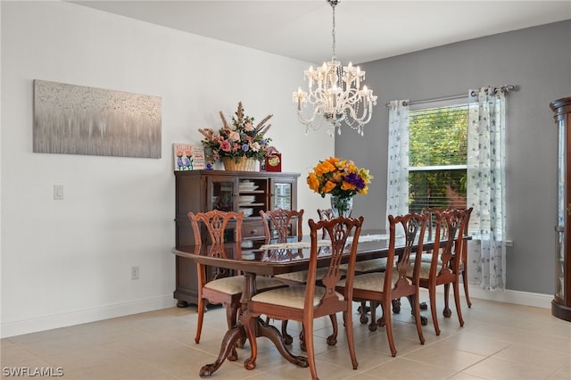 tiled dining space featuring an inviting chandelier