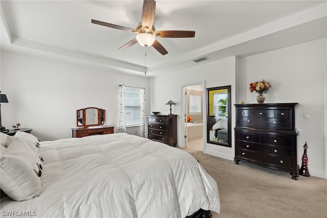 bedroom featuring light carpet, multiple windows, connected bathroom, and ceiling fan