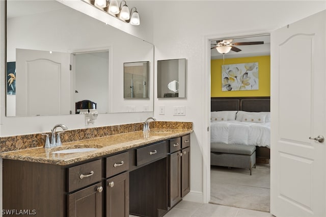 bathroom featuring tile patterned flooring, ceiling fan, and dual bowl vanity