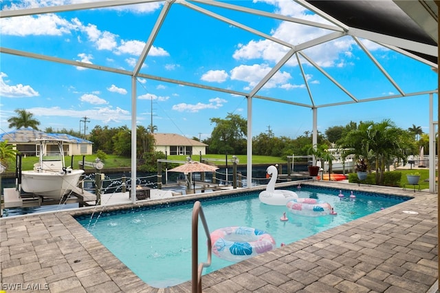 view of pool with a patio and glass enclosure