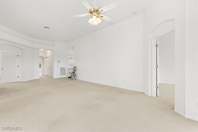 unfurnished living room featuring light carpet and ceiling fan