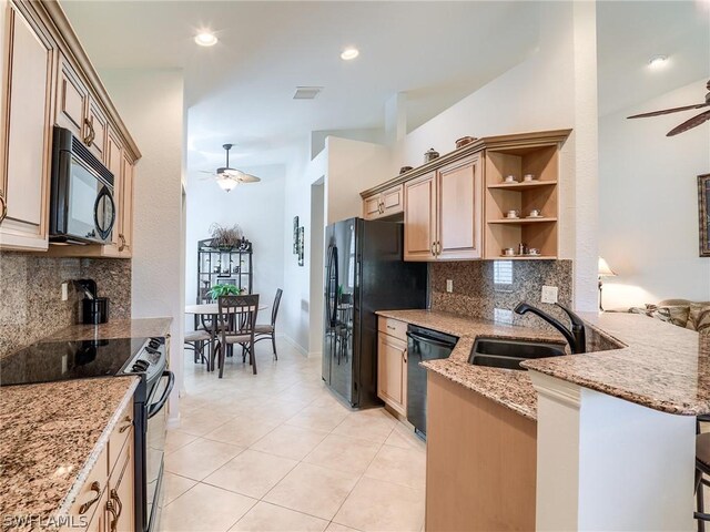 kitchen with black appliances, backsplash, light tile patterned floors, light stone countertops, and ceiling fan