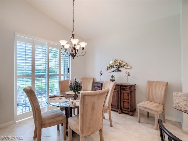 dining area featuring vaulted ceiling, light tile patterned floors, and an inviting chandelier