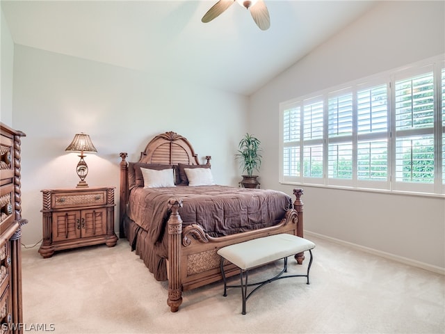 bedroom featuring lofted ceiling, light carpet, and ceiling fan