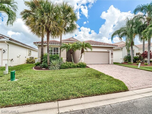 mediterranean / spanish home with a garage and a front yard