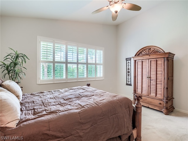 bedroom with light carpet, lofted ceiling, and ceiling fan