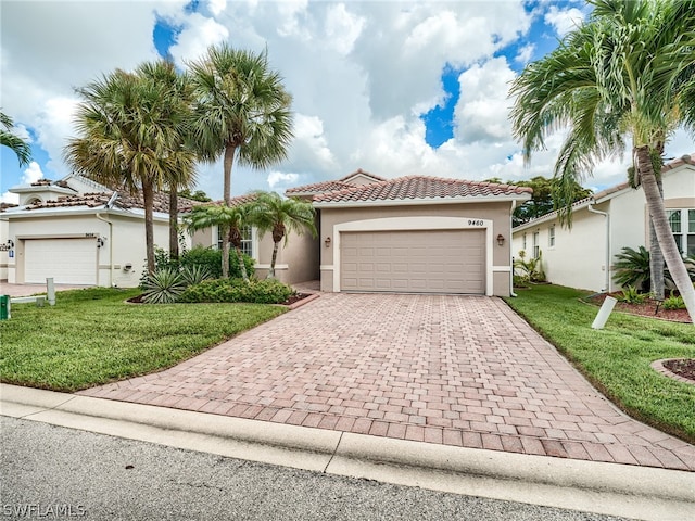 mediterranean / spanish-style home with a garage and a front yard