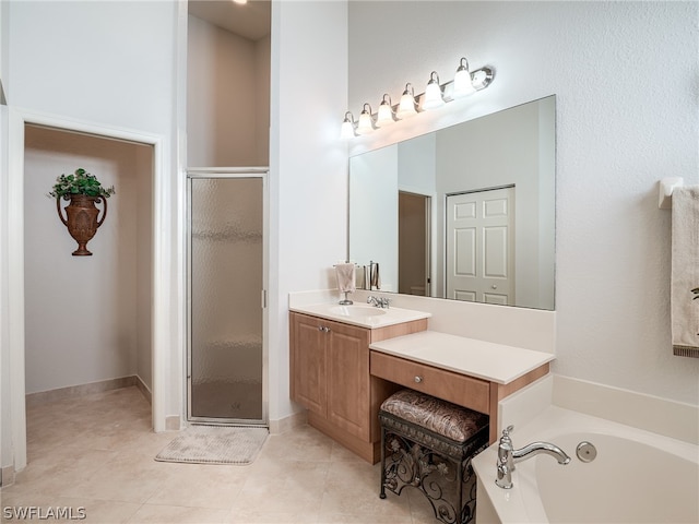 bathroom featuring vanity, plus walk in shower, and tile patterned flooring