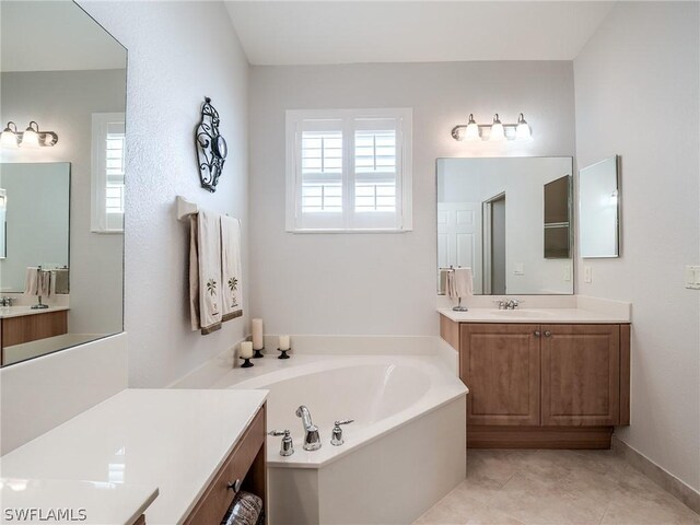 bathroom featuring vanity, tile patterned floors, and a bathtub