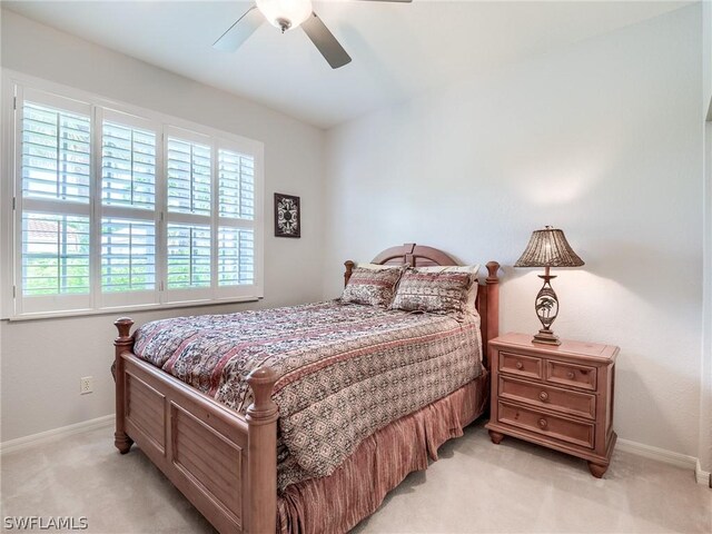 bedroom featuring light carpet and ceiling fan