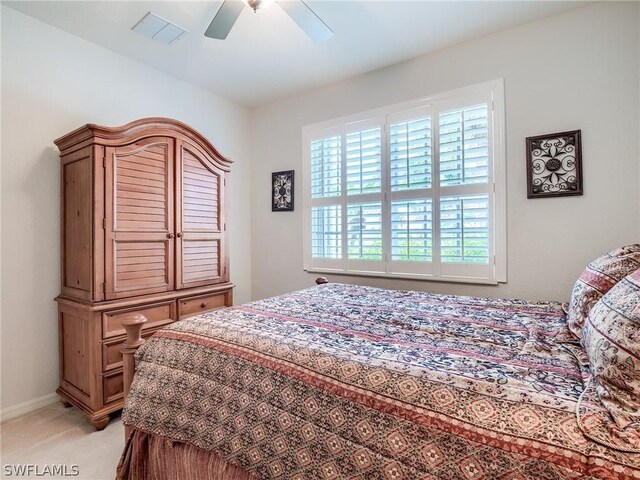 bedroom featuring light carpet and ceiling fan