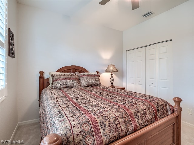 carpeted bedroom featuring ceiling fan and a closet