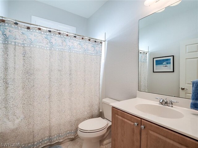 bathroom with vanity, tile patterned floors, and toilet