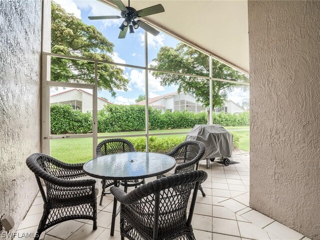 sunroom / solarium featuring ceiling fan