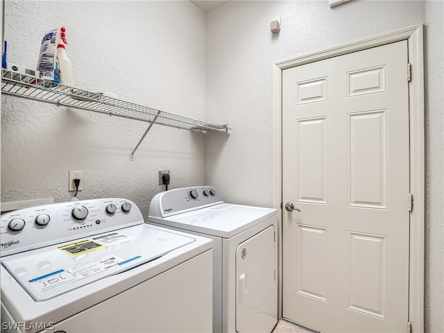 clothes washing area with washer and clothes dryer