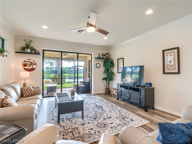 living room with ornamental molding, ceiling fan, and hardwood / wood-style floors