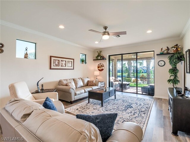 living room featuring crown molding, ceiling fan, and wood-type flooring