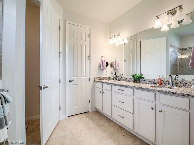 bathroom with double sink vanity and tile patterned flooring