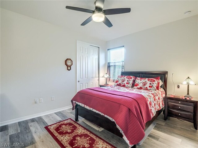 bedroom featuring light hardwood / wood-style floors, a closet, and ceiling fan