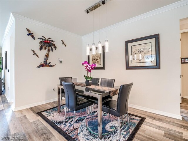 dining room featuring light wood-type flooring and ornamental molding