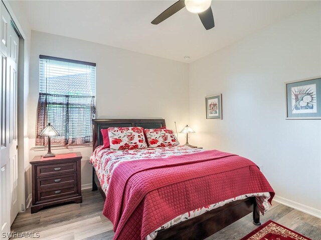 bedroom featuring light hardwood / wood-style floors, a closet, and ceiling fan