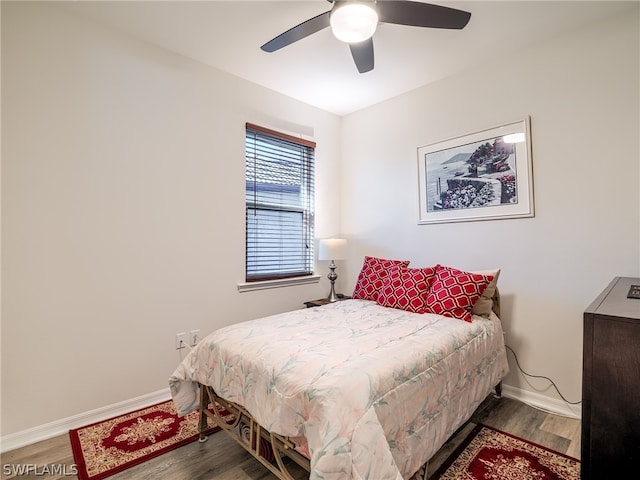 bedroom with ceiling fan and hardwood / wood-style flooring