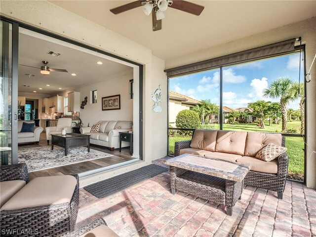 sunroom with ceiling fan