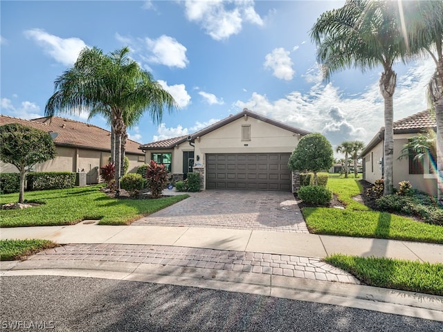 view of front of home with a garage and a front lawn