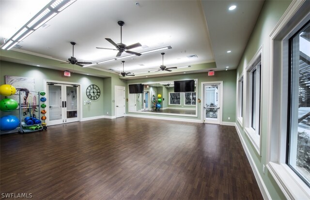 interior space with wood-type flooring, a raised ceiling, french doors, and ceiling fan