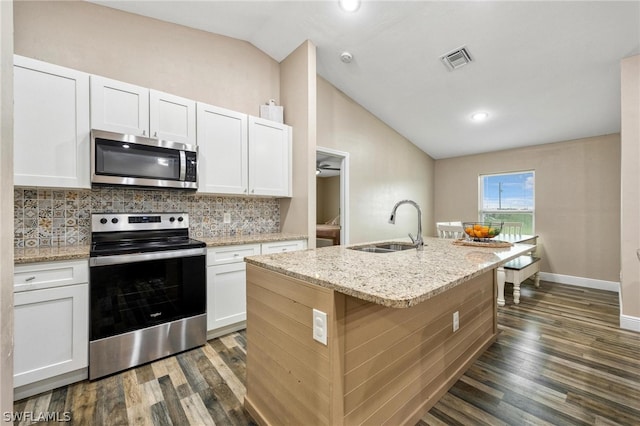 kitchen featuring appliances with stainless steel finishes, white cabinets, sink, an island with sink, and dark wood-type flooring