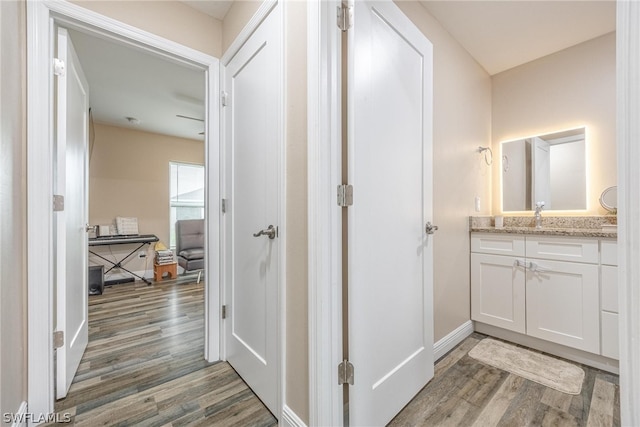 hall with sink and wood-type flooring