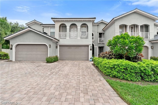 view of front of home with a balcony and a garage