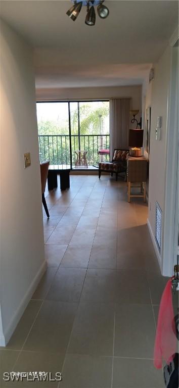 hallway with tile patterned flooring