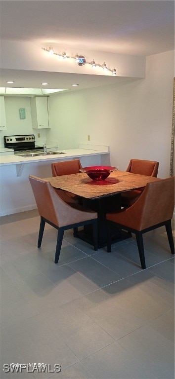 tiled dining room with sink