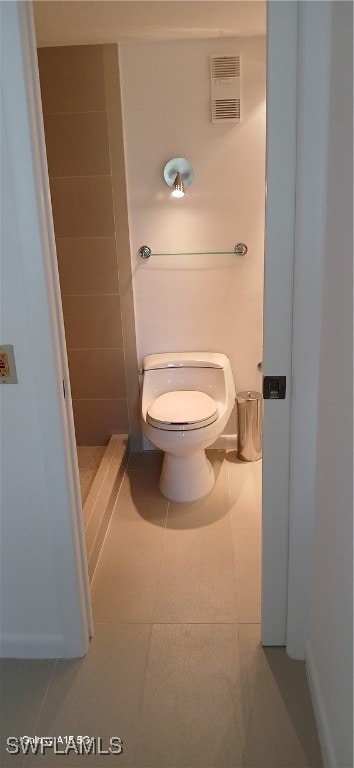 bathroom featuring toilet and tile patterned flooring