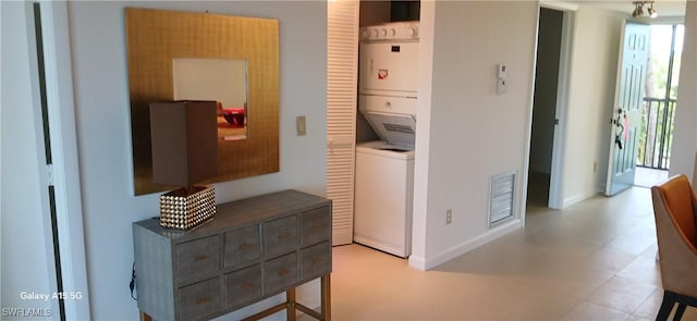 hall with stacked washing maching and dryer