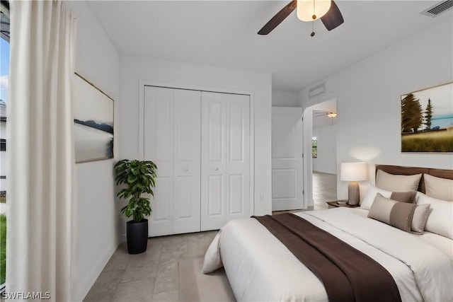 bedroom with ceiling fan and a closet