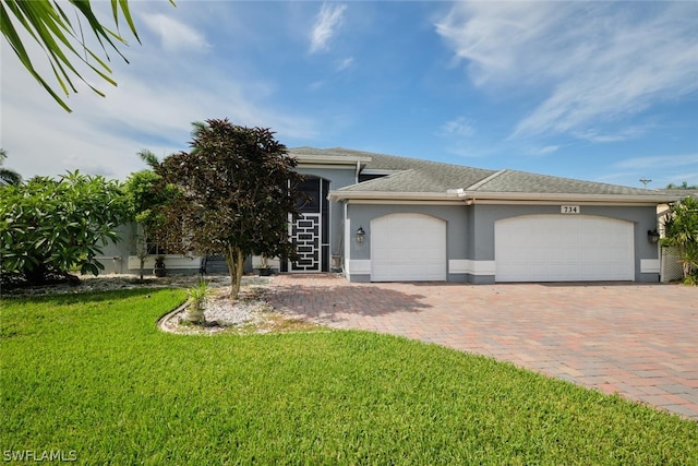 view of front of property with a garage and a front lawn