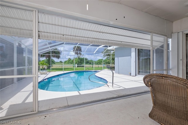 view of swimming pool with a lanai and a patio