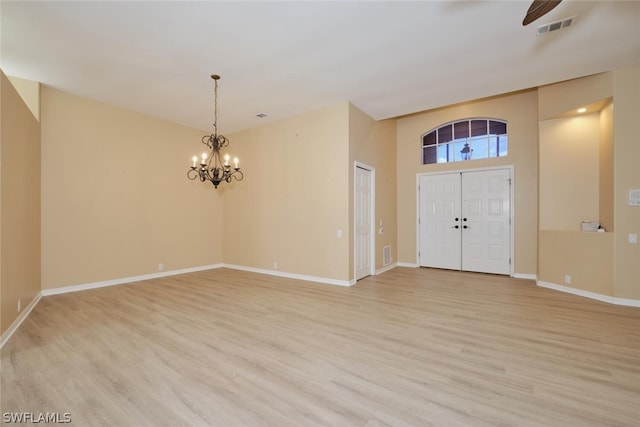 entrance foyer with an inviting chandelier and light wood-type flooring