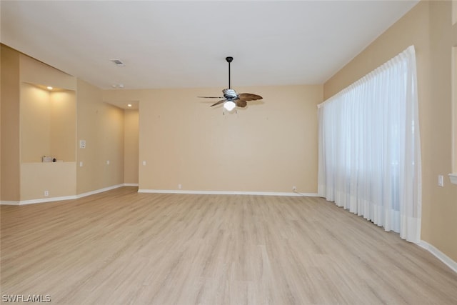 spare room with ceiling fan and light wood-type flooring