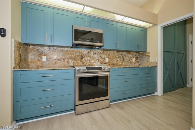 kitchen with light stone counters, decorative backsplash, light hardwood / wood-style floors, and appliances with stainless steel finishes