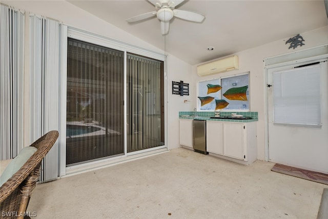 view of patio / terrace featuring a wall mounted AC and ceiling fan