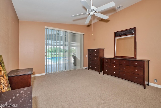 bedroom with light carpet, access to exterior, lofted ceiling, and ceiling fan