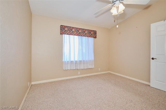 spare room featuring carpet, lofted ceiling, and ceiling fan