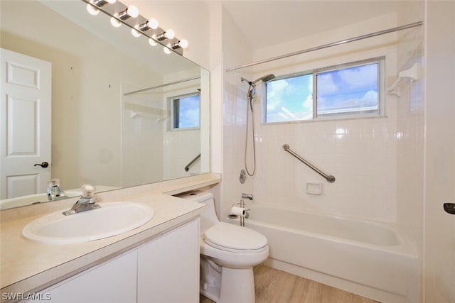 full bathroom with tiled shower / bath combo, vanity, hardwood / wood-style flooring, and a wealth of natural light