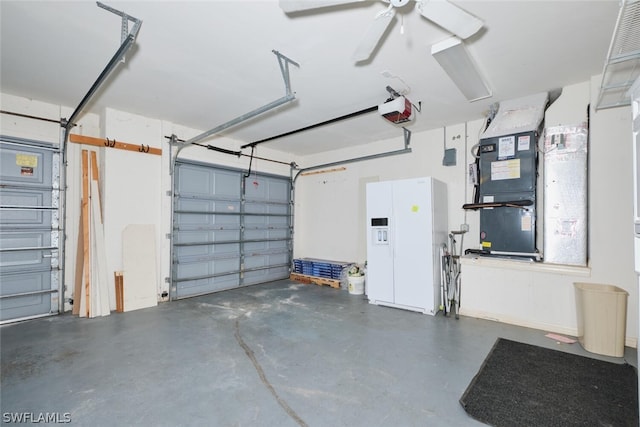 garage with ceiling fan, a garage door opener, heating unit, and white fridge with ice dispenser